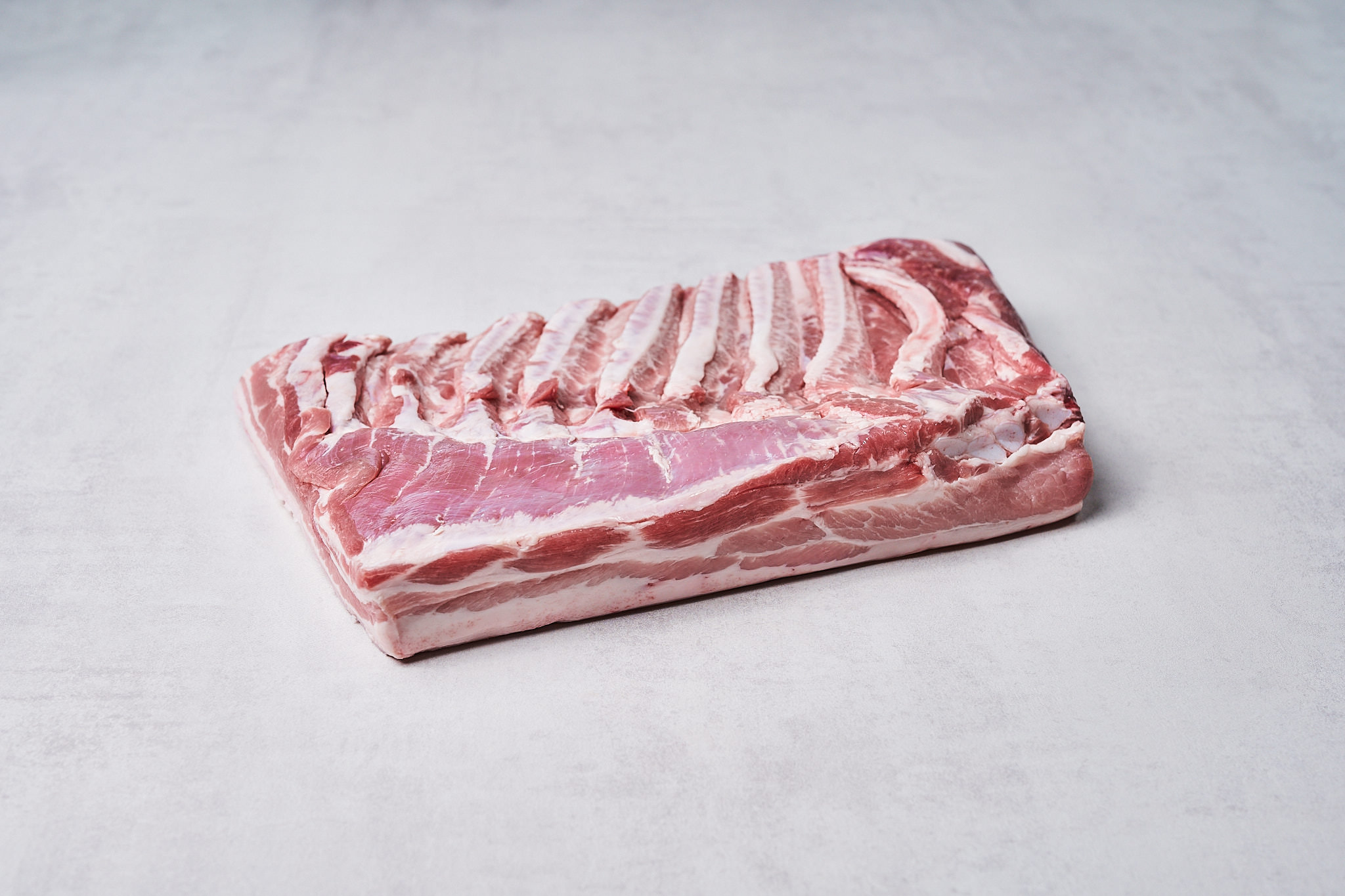 Schweinebauch vom Strohschwein Schweinebauch vom Strohschwein ohne Schwarte Produktfotografie